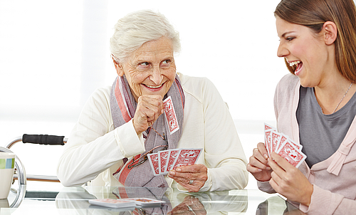 Senior woman playing cards