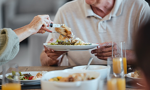 Plate, food and thanksgiving with a meal in the hands of a senior man during a family lunch for celebration. Party, health and social with a group of people eating together in the holiday season