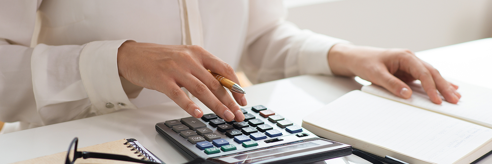 Closeup of woman calculating expenses